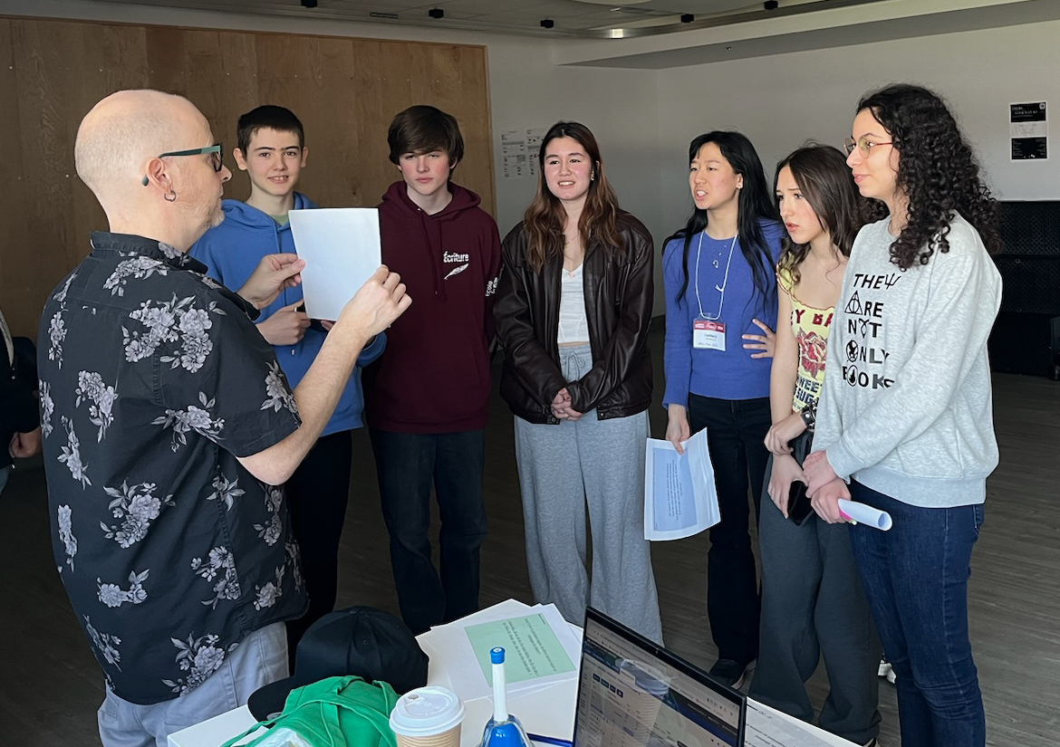 French Stream Finalists, Leïla Malo, Sara-Joelle Yao, and Cynthia Li visit École secondaire publique de La Salle. Cynthia is pictured doing a poetry exercise with La Salle teacher and students.
