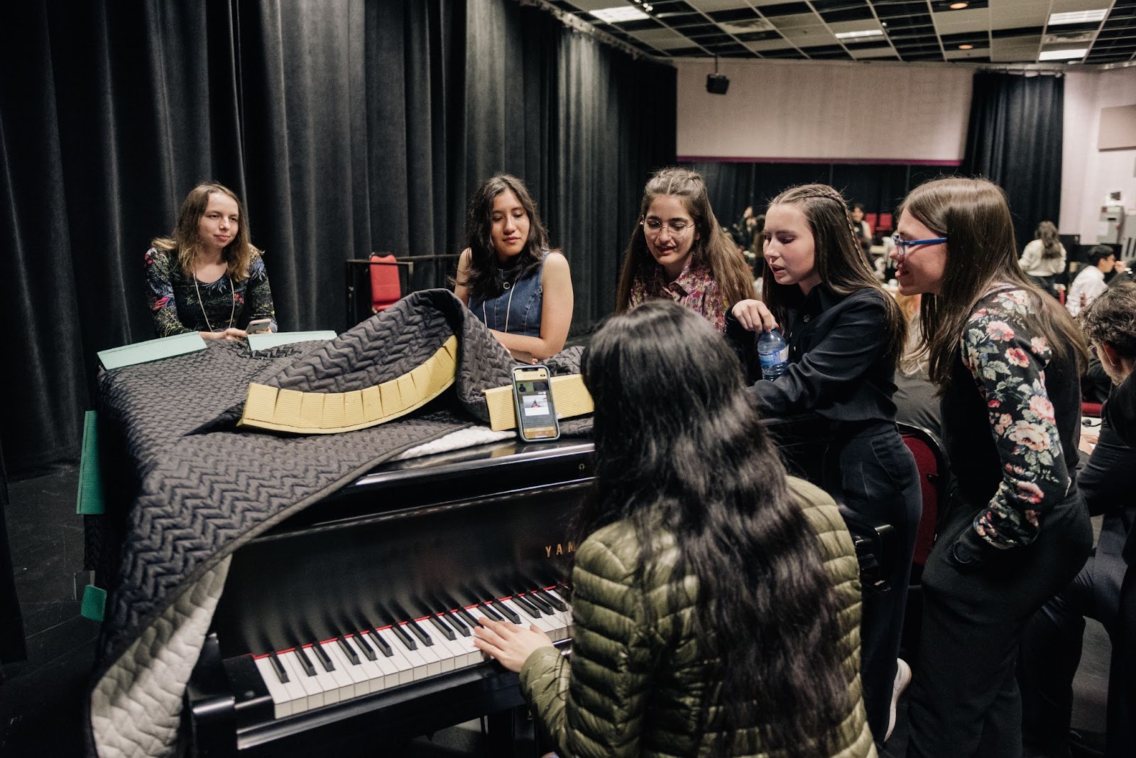 Students discover the backstage piano and have a pre-show sing-along…