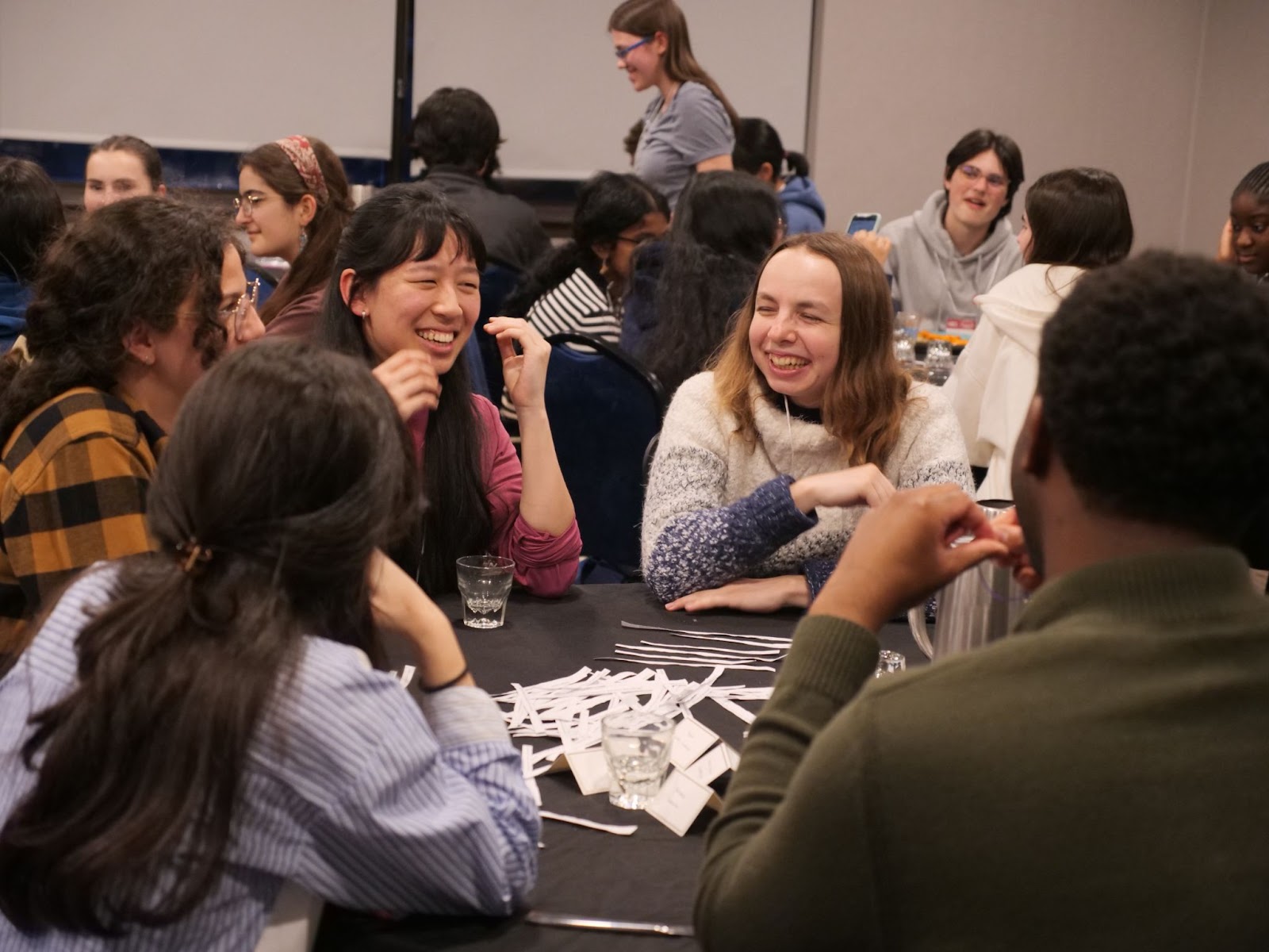 Finalist Cynthia Li and FutureVerser Marie-Pauline Chaffanjon pictured laughing, as they string verses together.