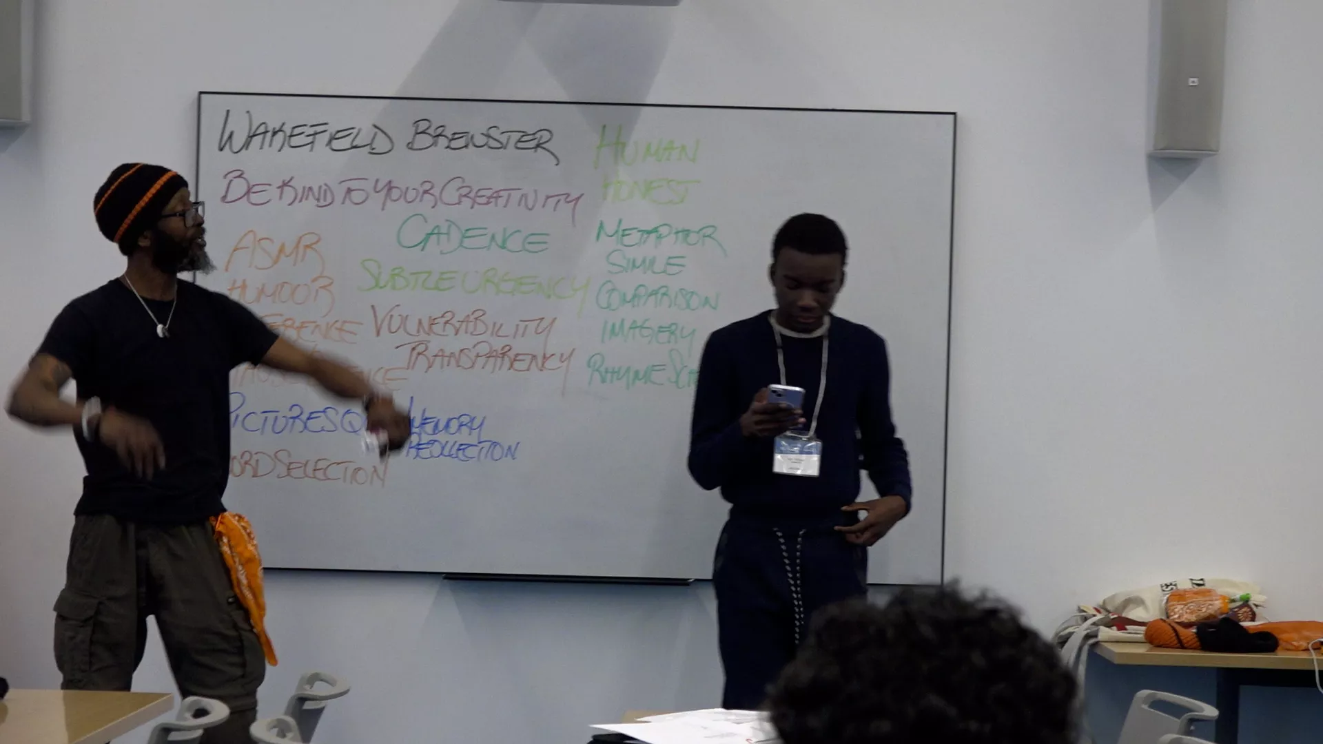 Wakefield Brewster encourages Aqil in reciting his poem.