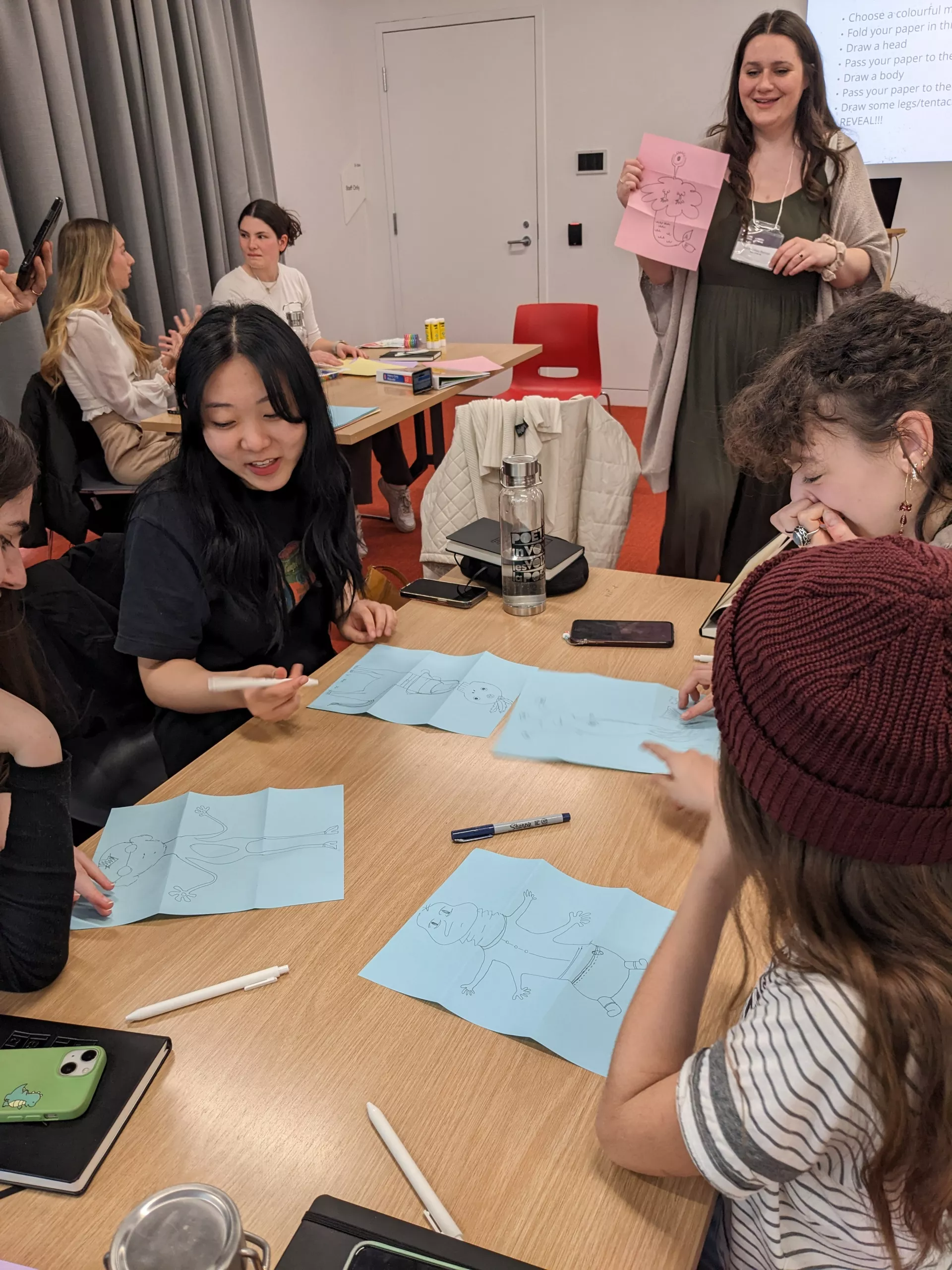 Vivian Sun and Moineau Shin Binon share a laugh while Sophie Gareau-Brennan leads them in a poetry translation workshop.