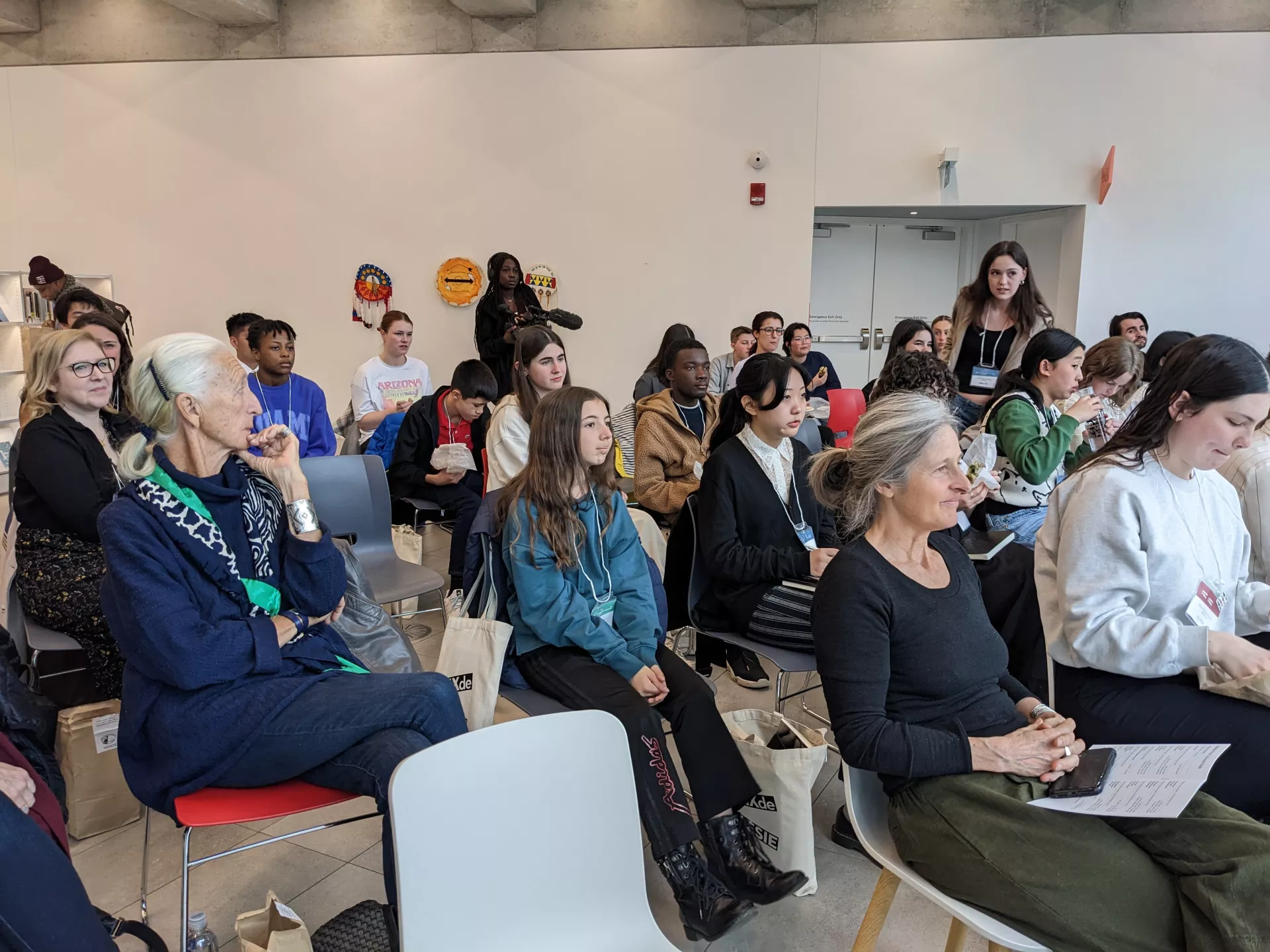 The crowd listening and enjoying their lunch.