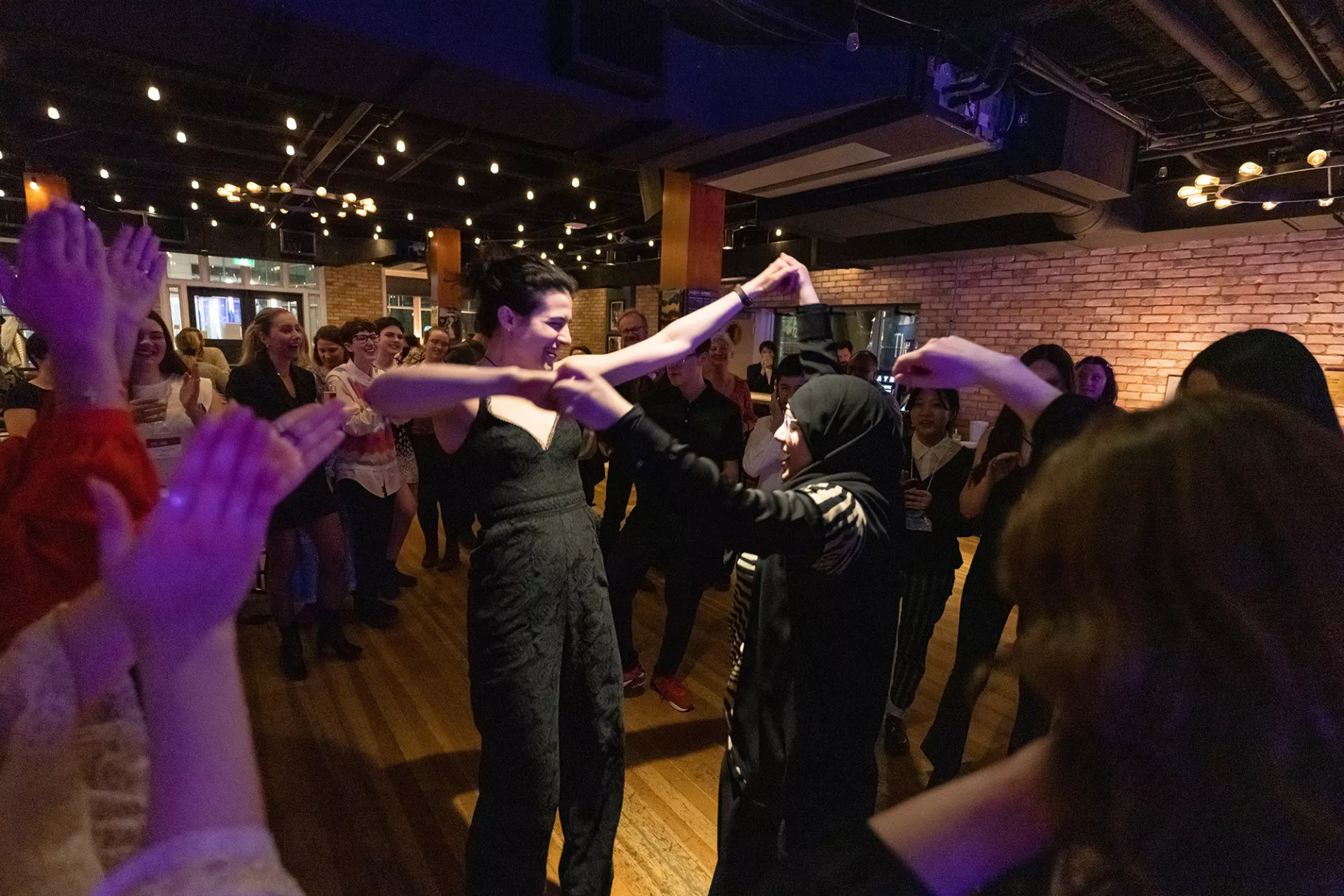 Liana Cusmano and Batool Ali share a dance.