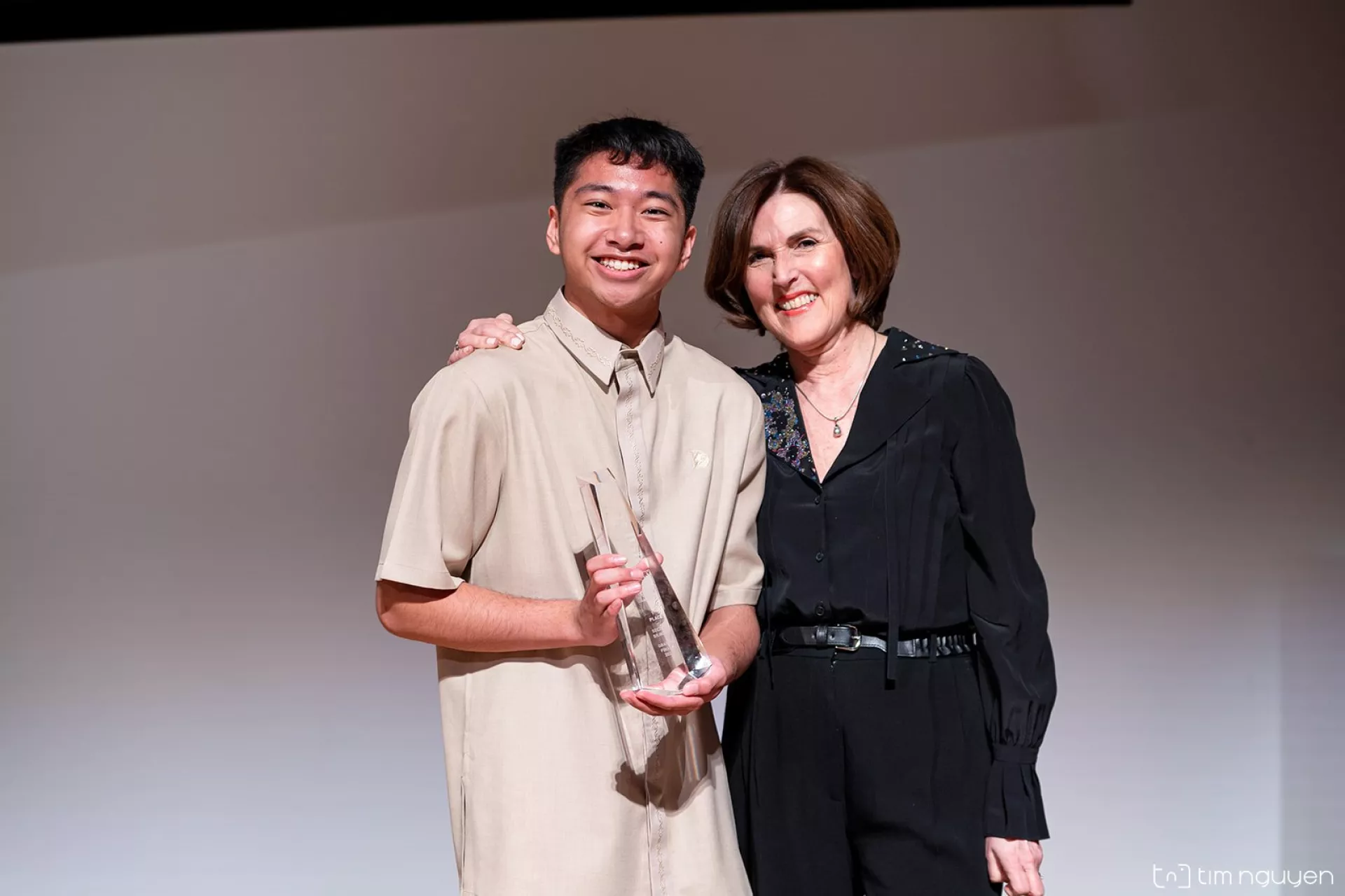 Aaronsaul Negre is congratulated by Johanne Blais on his 1st prize placing in the Bilingual Category.